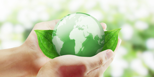 Hands holding Green globe of Earth